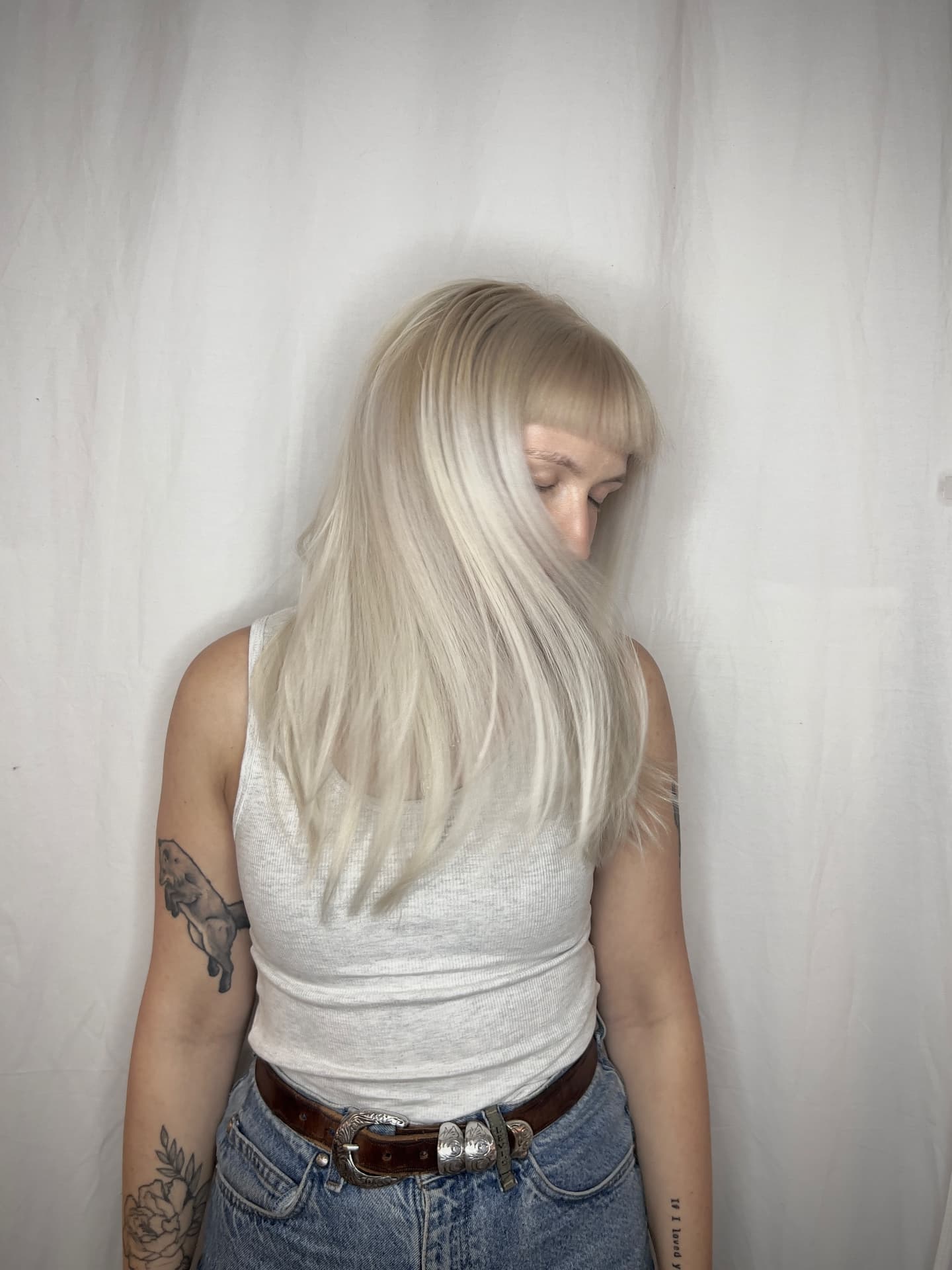 Icy platinum blonde with fringe and long layers