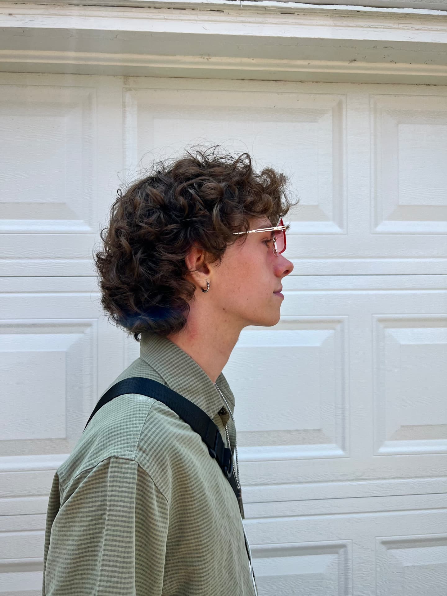 Curly perm styled into a textured cut